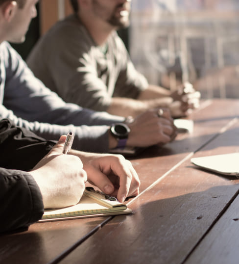 Team reviewing investment documents at a boardroom table